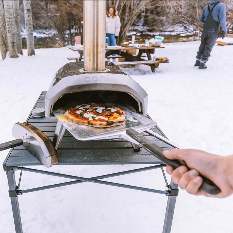 Camper holding the Ooni Pizza Peel by the heat-resistant handle