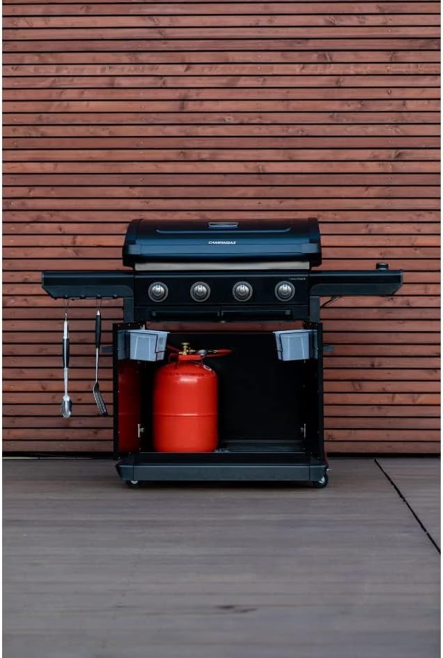 Campingaz 4 Series Onyx S Outdoor Gas BBQ Grill in backyard with propane tank, ideal for UAE outdoor cooking experiences.