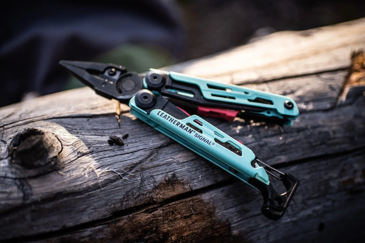 Leatherman Signal multi-tool on a log, versatile tool for survival in rugged terrains, ideal for adventurers in the UAE.