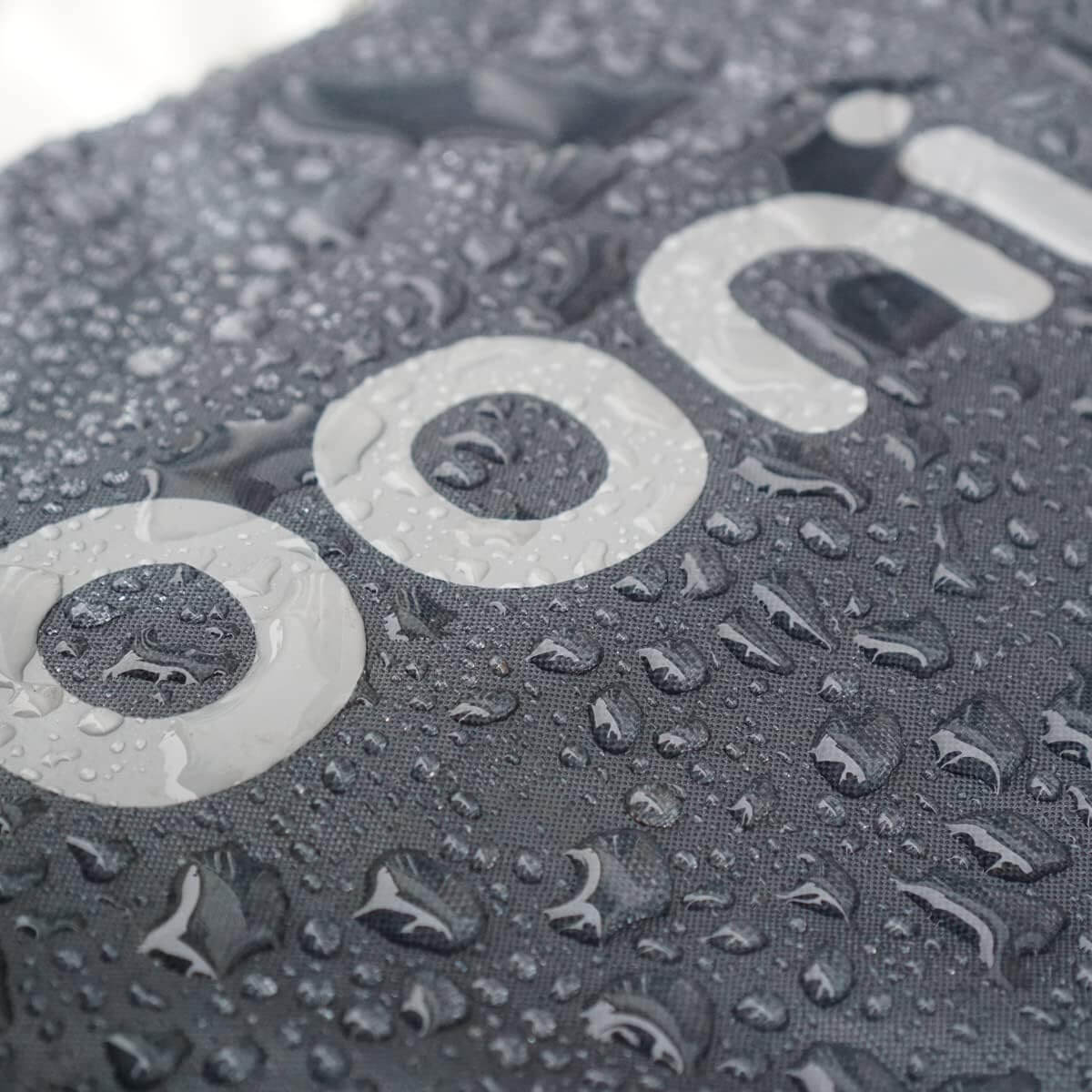 Close-up of Ooni Carry Cover for Ooni Koda 12 with water droplets showcasing durability in wet conditions