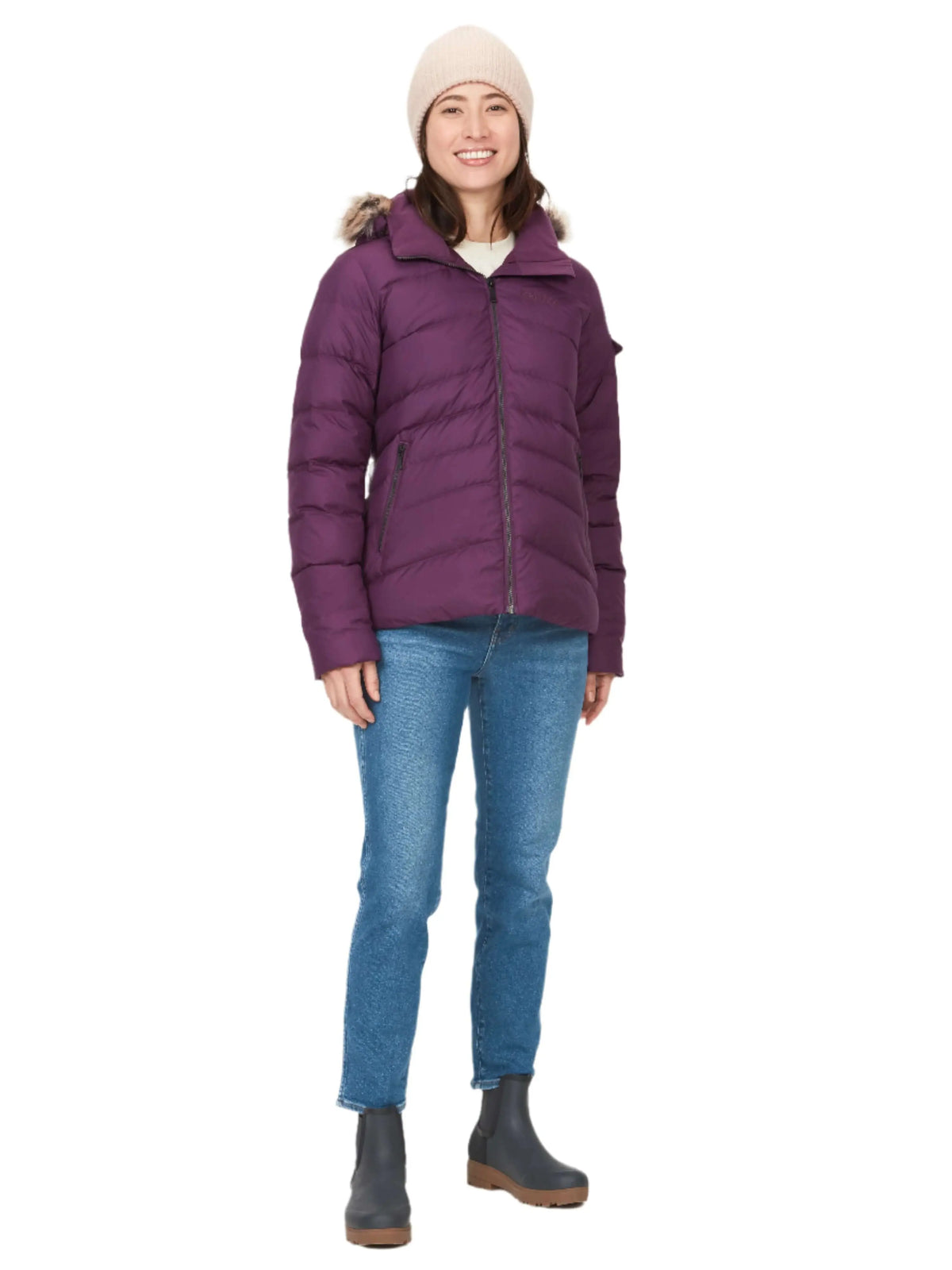 Woman wearing the Marmot Ithaca Jacket while winter hiking in the mountains