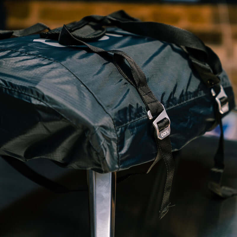 Ooni Carry Cover for Ooni Koda 12 showing durable straps and weatherproof design on a table