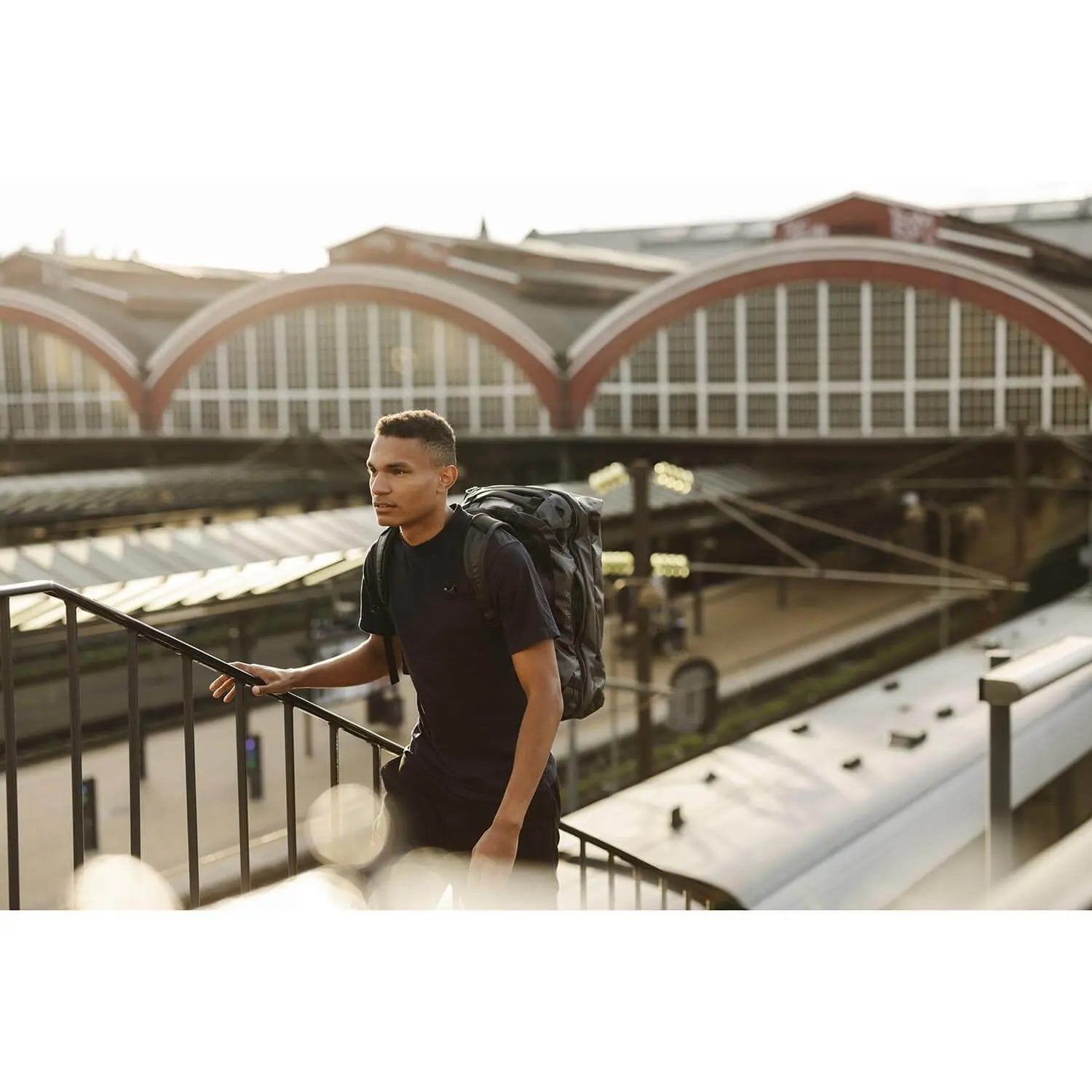 Man walking with a rugged Transporter Squffel 44 backpack in an urban setting.
