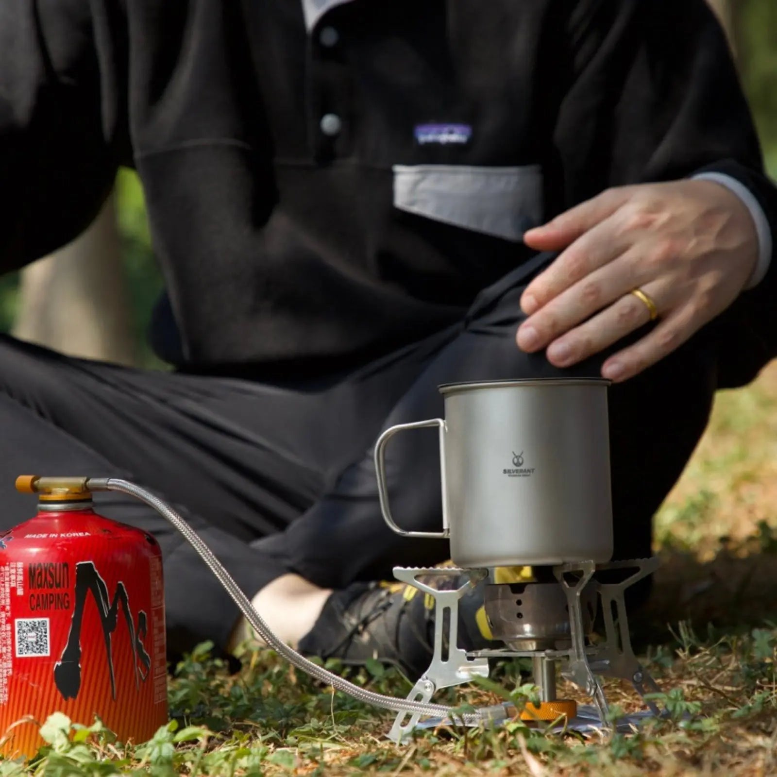 SilverAnt Ultralight Titanium Cup with Lid on a camping stove outdoors