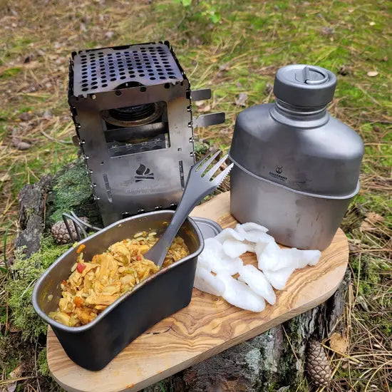 SilverAnt Titanium Canteen Military Mess Kit in outdoor setting with food and portable stove