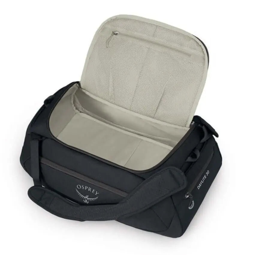 Osprey Daylite Duffel 30 in black with open top showing spacious interior and zippered pockets, adaptable for gym, office or travel use.