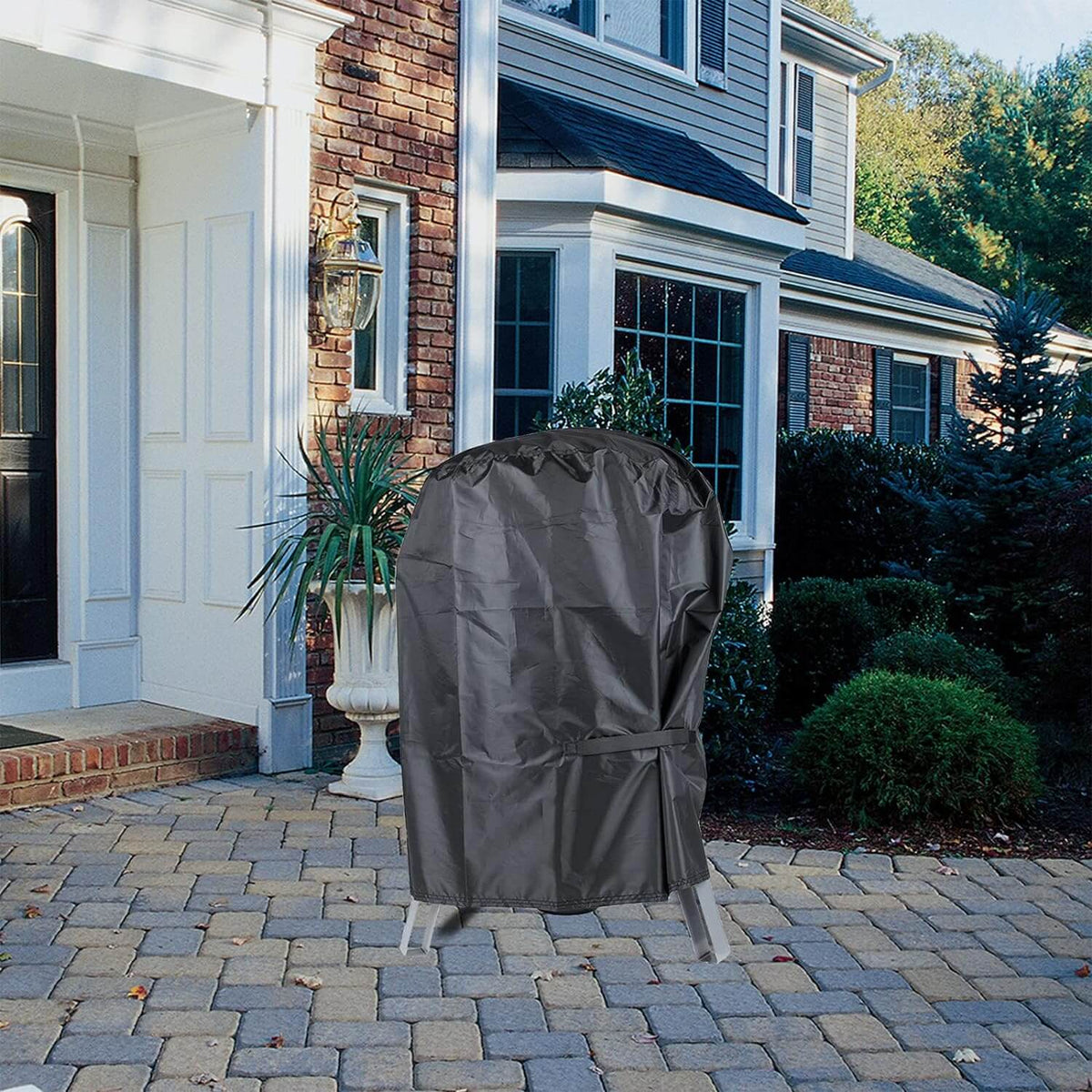 Realcook 17-Inch BBQ Smoker Grill Cover shielding an outdoor grill