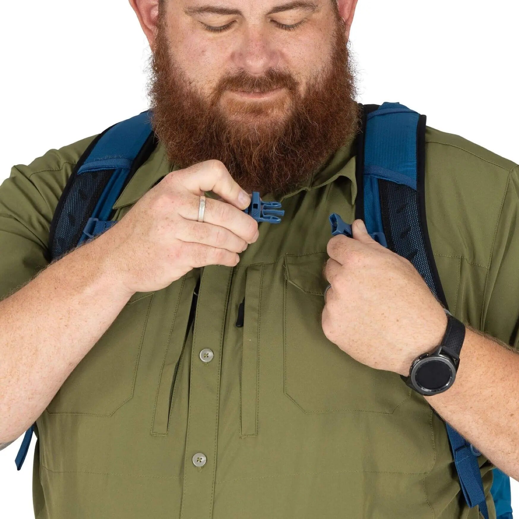 Man adjusting the strap of the Osprey Talon 22 Extended Fit - Men backpack while wearing a green shirt.