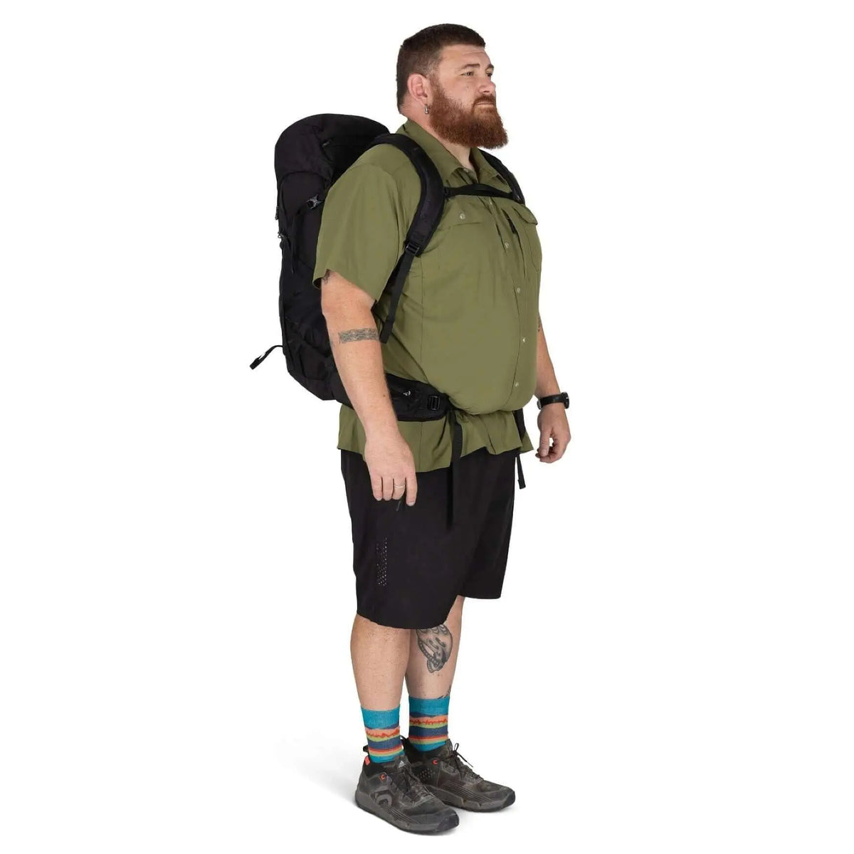 Man wearing Osprey Talon 33 Extended Fit daypack, showcasing versatile design for broader body types, ideal for travel and day trips.