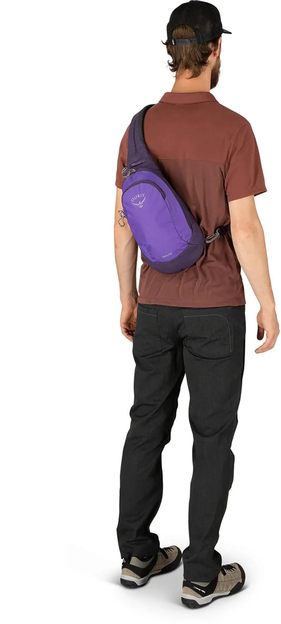 Osprey Daylite Sling in purple worn over shoulder, featuring easy access phone sleeve and dual zippers, shown from the back.