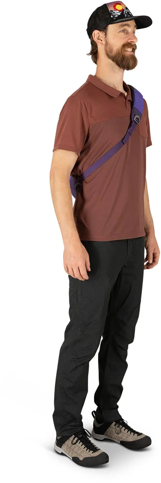 Man wearing Osprey Daylite Sling in purple with ambidextrous shoulder strap and phone sleeve, showcasing style and comfort.