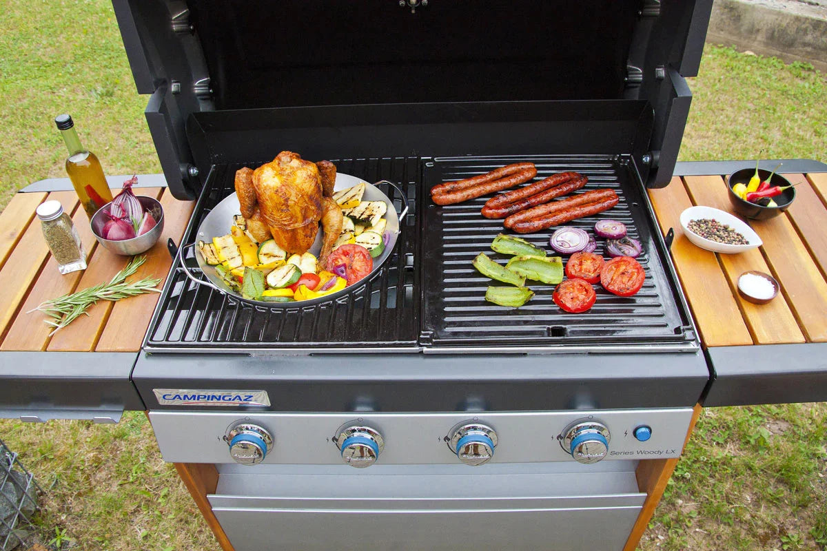 Campingaz Culinary Modular Poultry Roaster on a barbecue grill with vegetables and sausages, perfect for outdoor cooking.