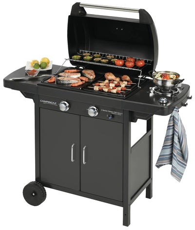 Campingaz 2 Series EXS Vario D Gas Grill with food, featuring a sleek design for outdoor cooking.