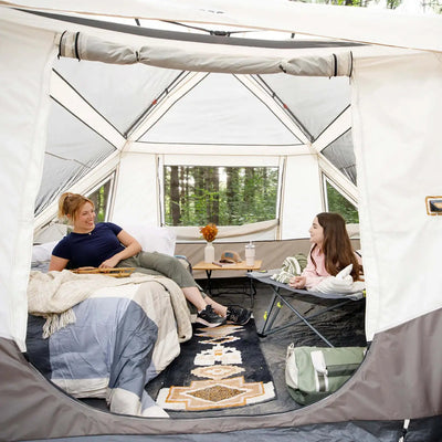10 Person Lighted Instant Pyramid Tent - 16' x 9' interior space with two campers enjoying the comfortable setup.