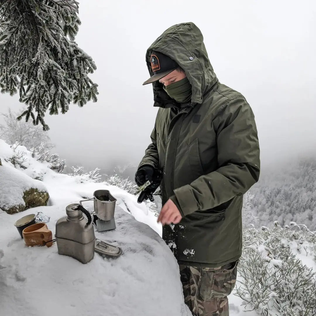 Person using SilverAnt Titanium Canteen Military Mess Kit in snowy outdoor setting