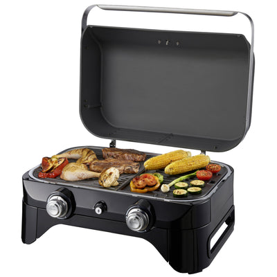 Campingaz Attitude 2100 LX Portable Gas Grill with open lid, grilling assorted vegetables and meats outdoors.
