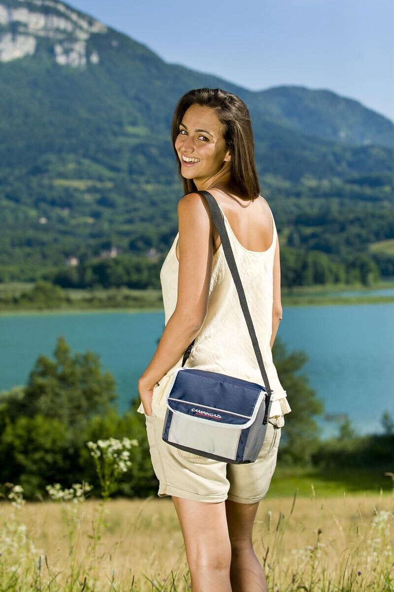 Woman enjoying nature with Campingaz Fold'N Cool Cooler bag, perfect for UAE outdoor adventures, against a scenic mountain backdrop.