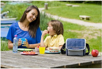 Family picnic with Campingaz Fold'N Cool Cooler bag on a sunny day in a park.