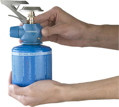 Campingaz Twister Plus PZ Stove held in hands, ideal for outdoor cooking and adventures in the UAE.