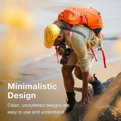 A hiker with an orange backpack and camera explores a rocky terrain, embodying minimalistic design in outdoor gear.