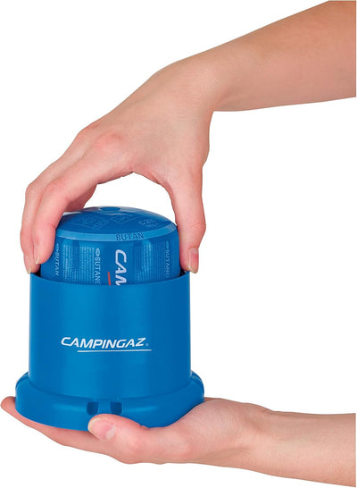 Hands holding Campingaz 206L Gas Lantern for outdoor lighting.