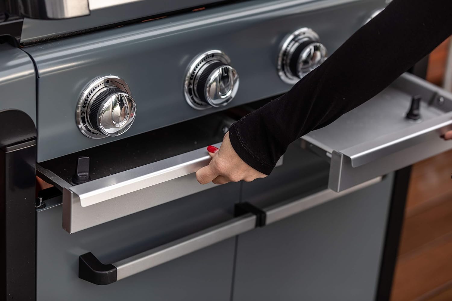 Person adjusting the Campingaz 3 Series Premium S Gas Grill controls