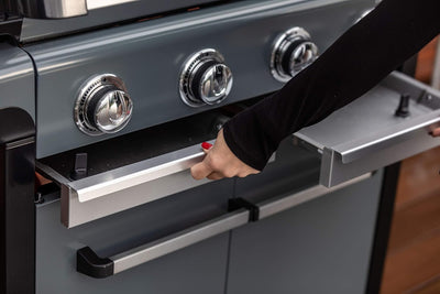 Person adjusting the Campingaz 3 Series Premium S Gas Grill controls