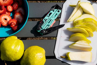 Leatherman Signal multi-tool with display box next to sliced fruit, showcasing its versatility for outdoor adventures in UAE.