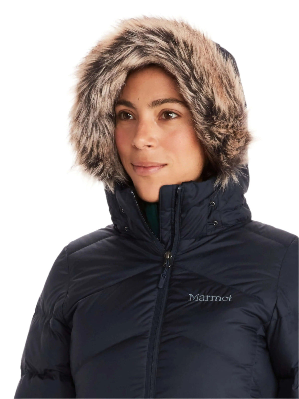 Woman wearing the Marmot Montreaux Coat with fur-lined hood, ideal for winter warmth.