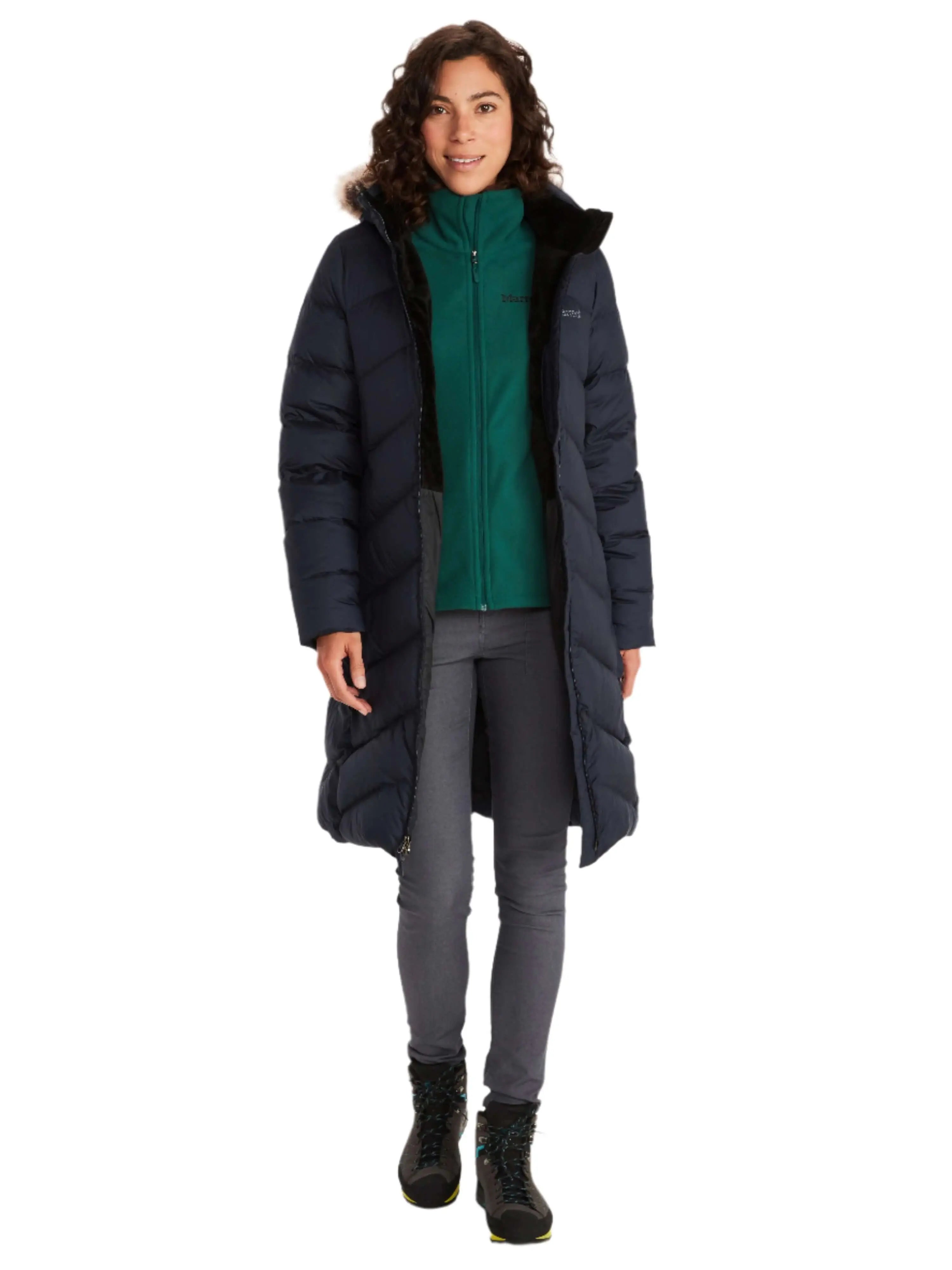 Woman wearing Marmot Montreaux Coat, a winter down jacket for cold weather.
