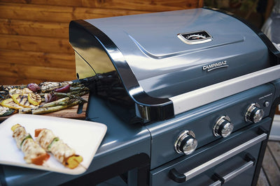 Campingaz 3 Series Premium S Gas Grill set up with skewers and grilled vegetables for outdoor cooking.