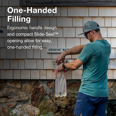 Person filling Osprey Hydraulics LT 1.5 L Reservoir with water using one hand against textured wall background.