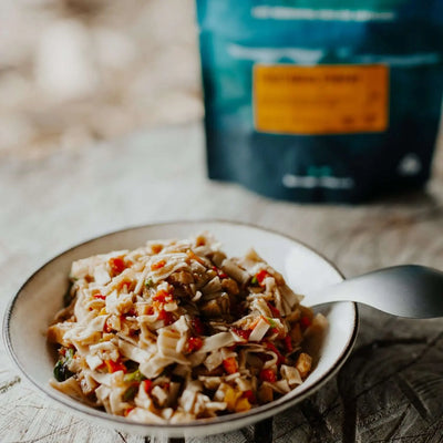 Back Country Cuisine Vegetarian Stir Fry plated meal with packaging in the background, perfect for outdoor adventures in the UAE.
