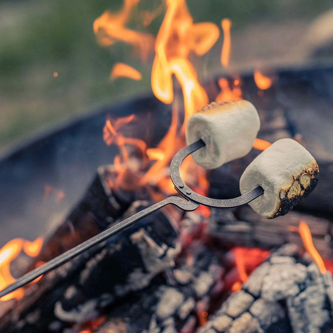 Barebones Cowboy Grill Roasting Sticks toasting marshmallows over campfire