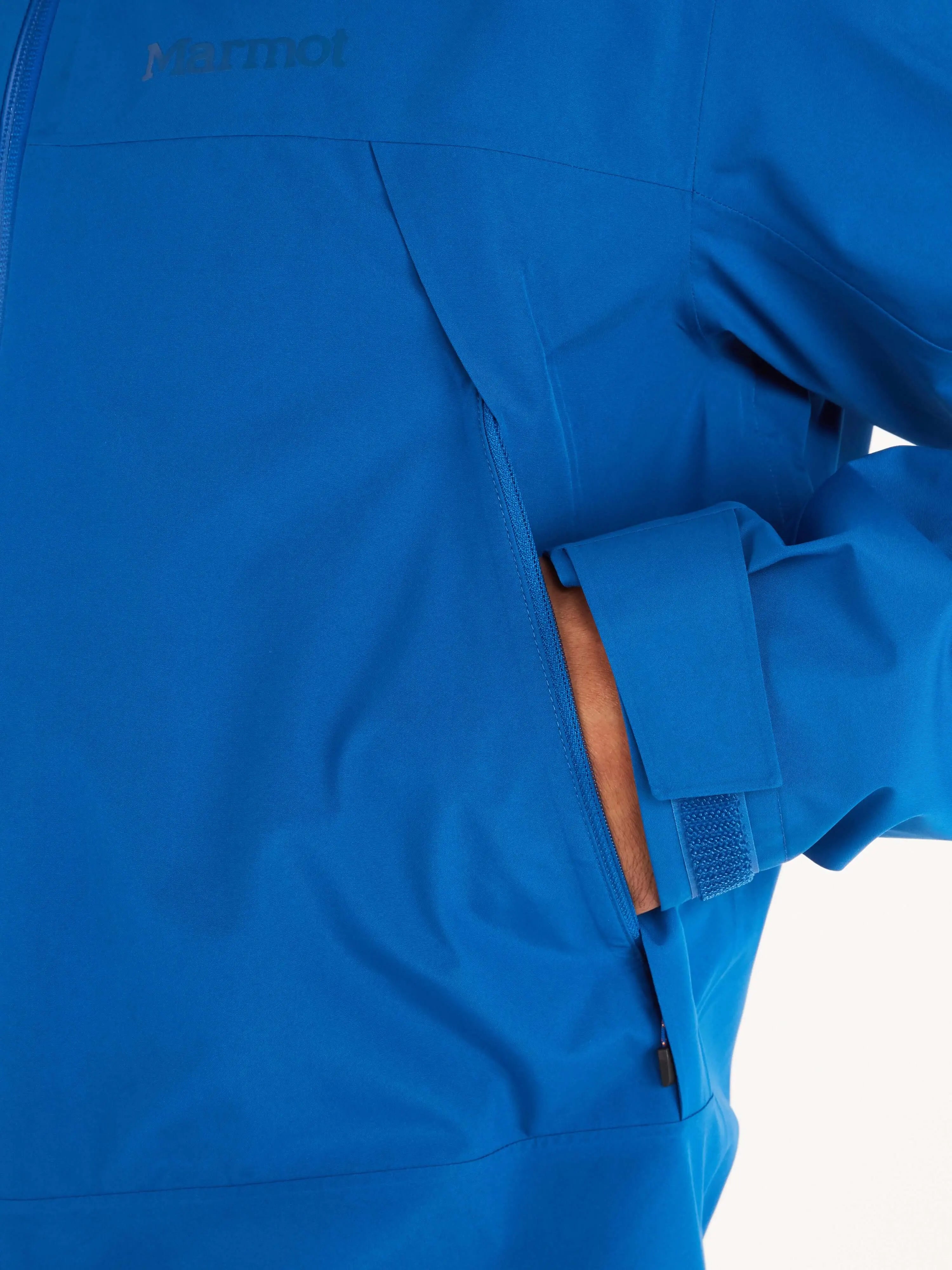 Close-up of Marmot Gore-Tex Minimalist Pro Jacket - Men's Shell in blue, showcasing zip pocket detail and waterproof material.