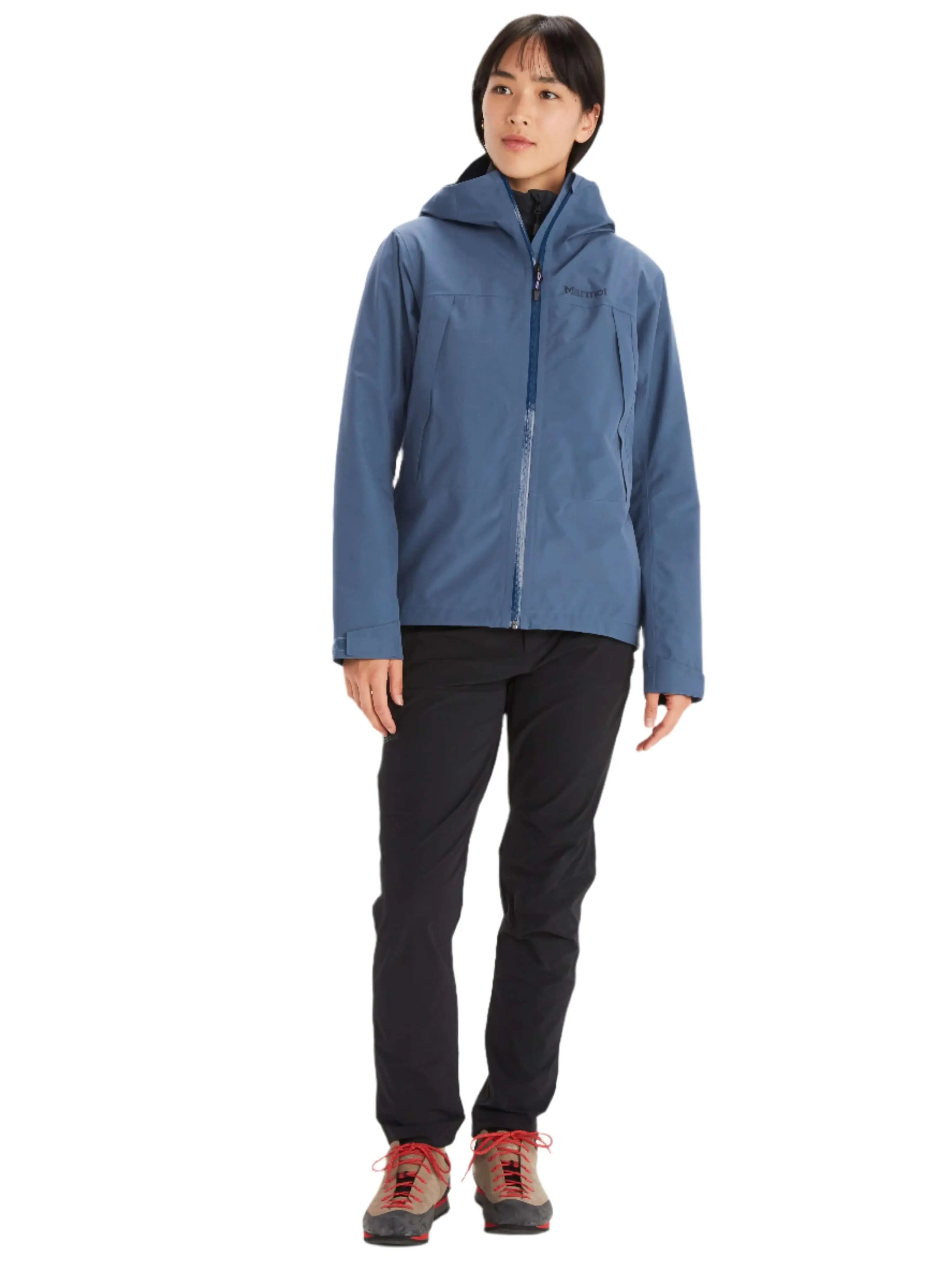 Woman wearing Marmot Gore-Tex Minimalist Pro Jacket in blue, designed for weather resistance and comfort.