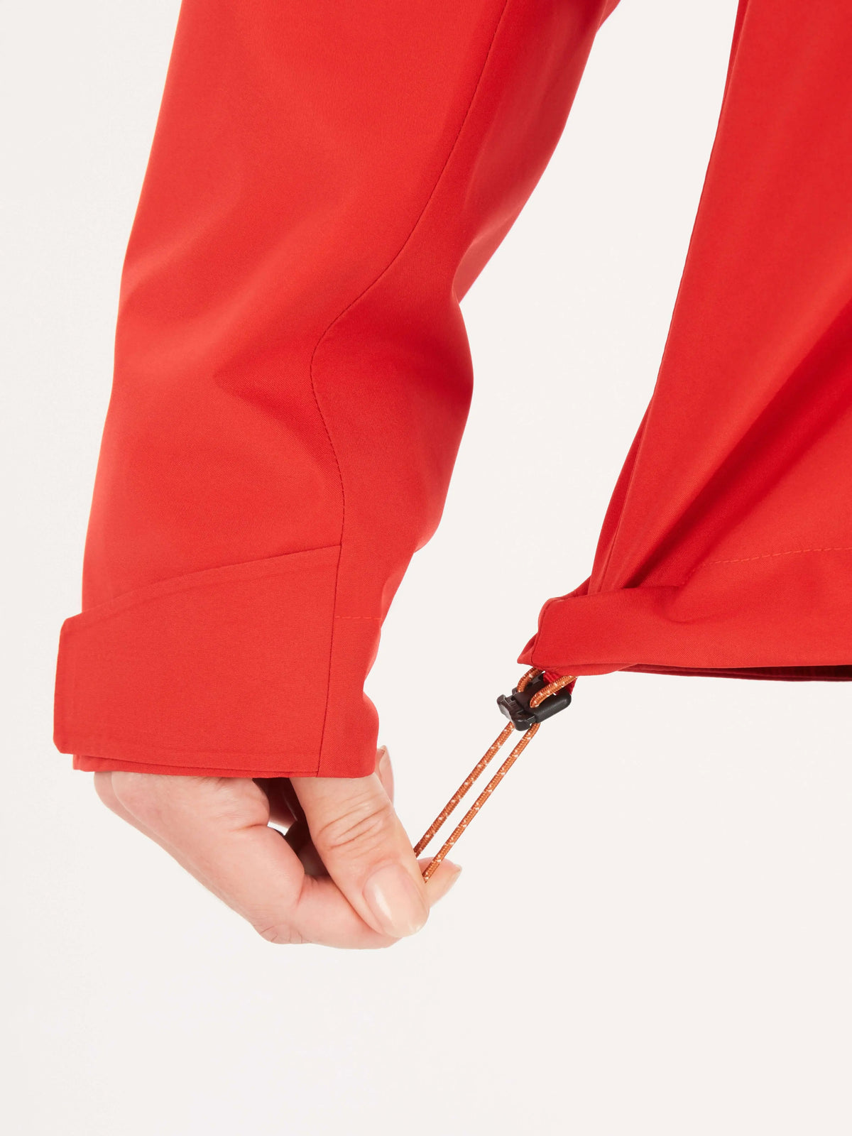 Close-up of Marmot Gore-Tex Minimalist Pro Jacket adjustable hem in red for women.