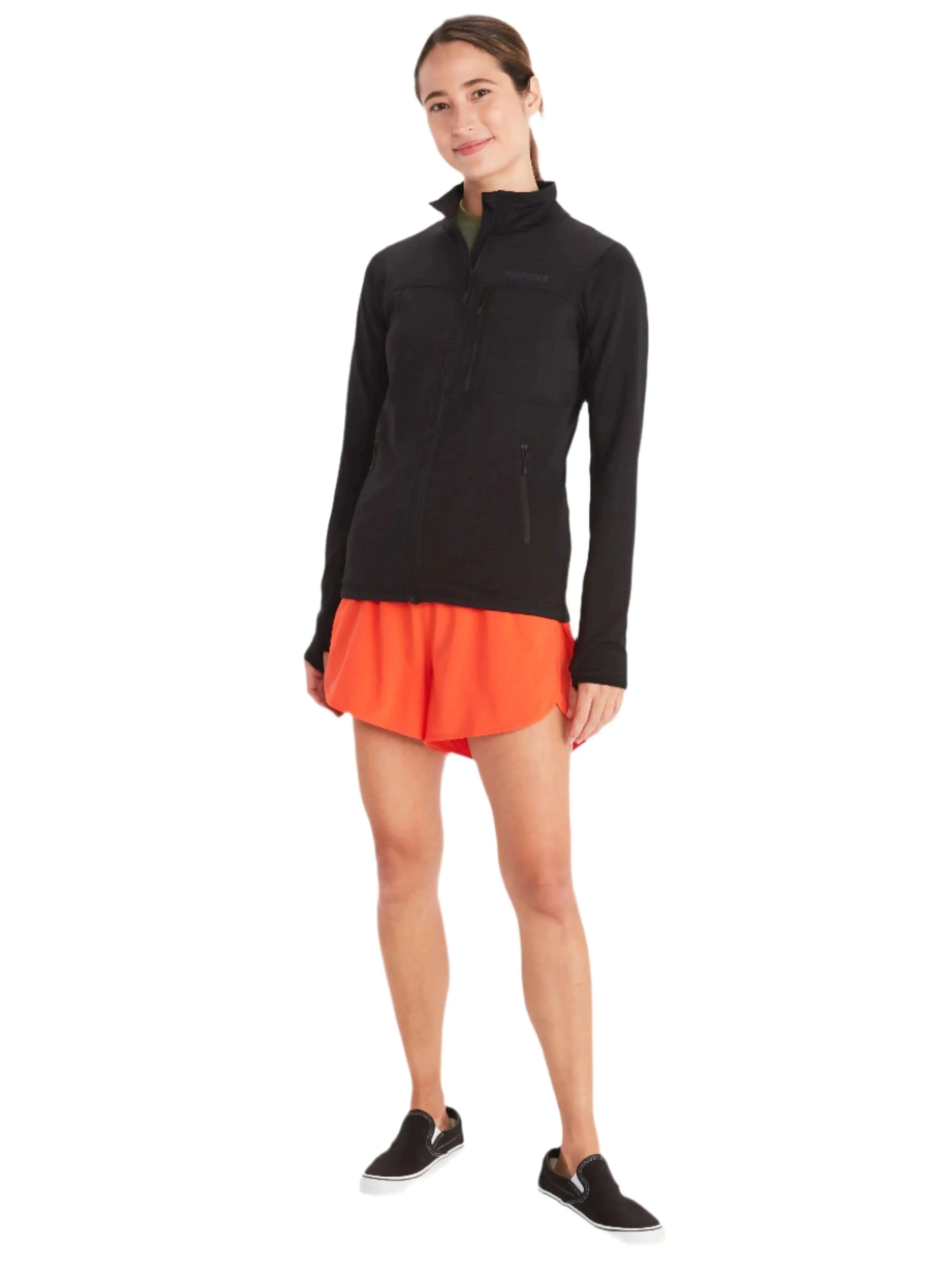 Woman wearing Marmot Preon Jacket - Women's Fleece Midlayer in black, ideal for outdoor excursions, paired with orange shorts.