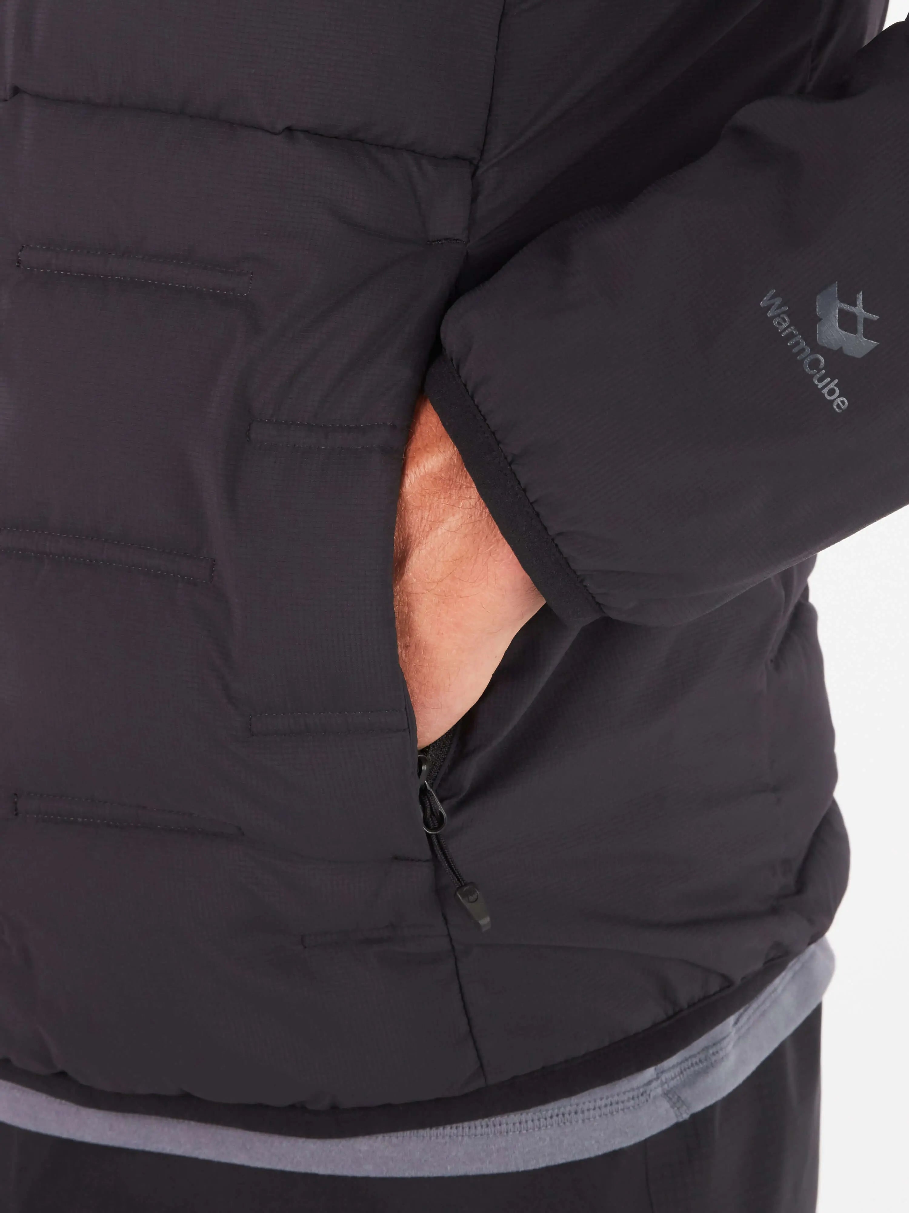 Close-up of Marmot Warmcube men's winter jacket with hand in pocket