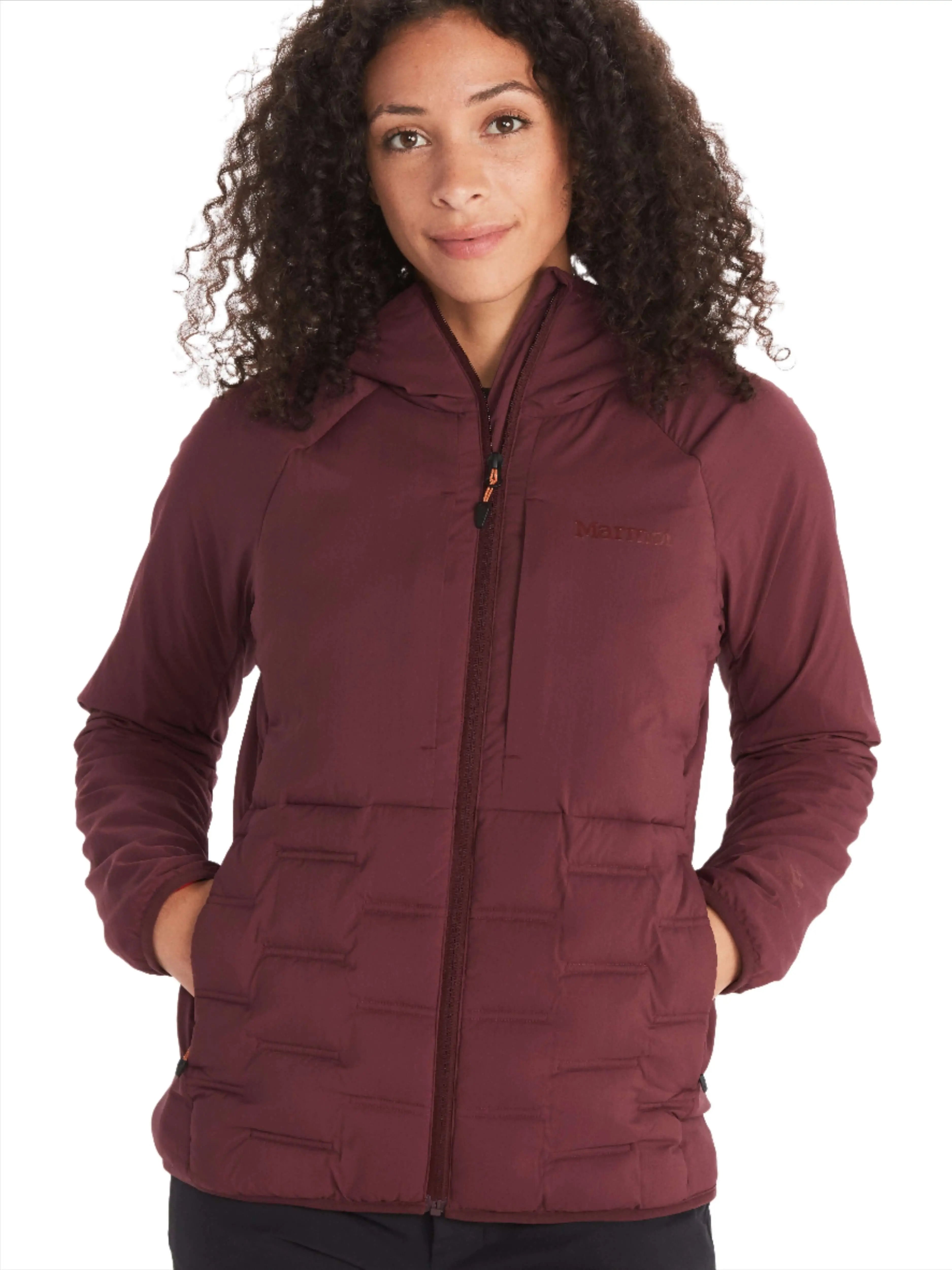 Woman wearing Marmot Warmcube Women's Active HB Jacket in burgundy for winter adventures.