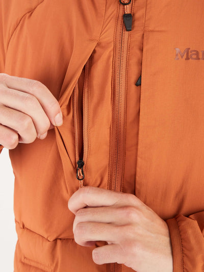Close-up of Marmot Warmcube Women's Active HB Jacket in orange, highlighting the zipper and WarmCube™ construction for winter adventures.
