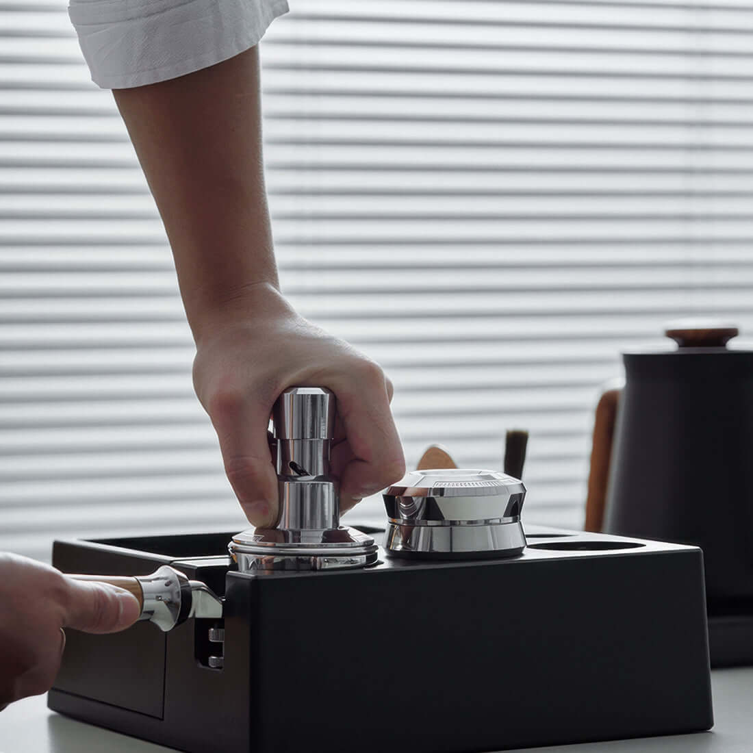 Person using the Muvna Titan Distributor 58mm coffee leveler for consistent coffee extraction.
