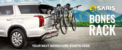 SUV with Saris Bones 3-Bike Trunk Rack carrying three bikes against mountain backdrop