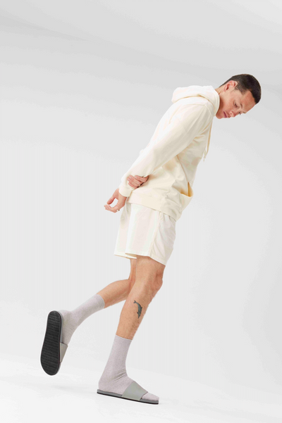 Man wearing Indosole Slides with recycled tire sole, showcasing sustainable men's footwear.