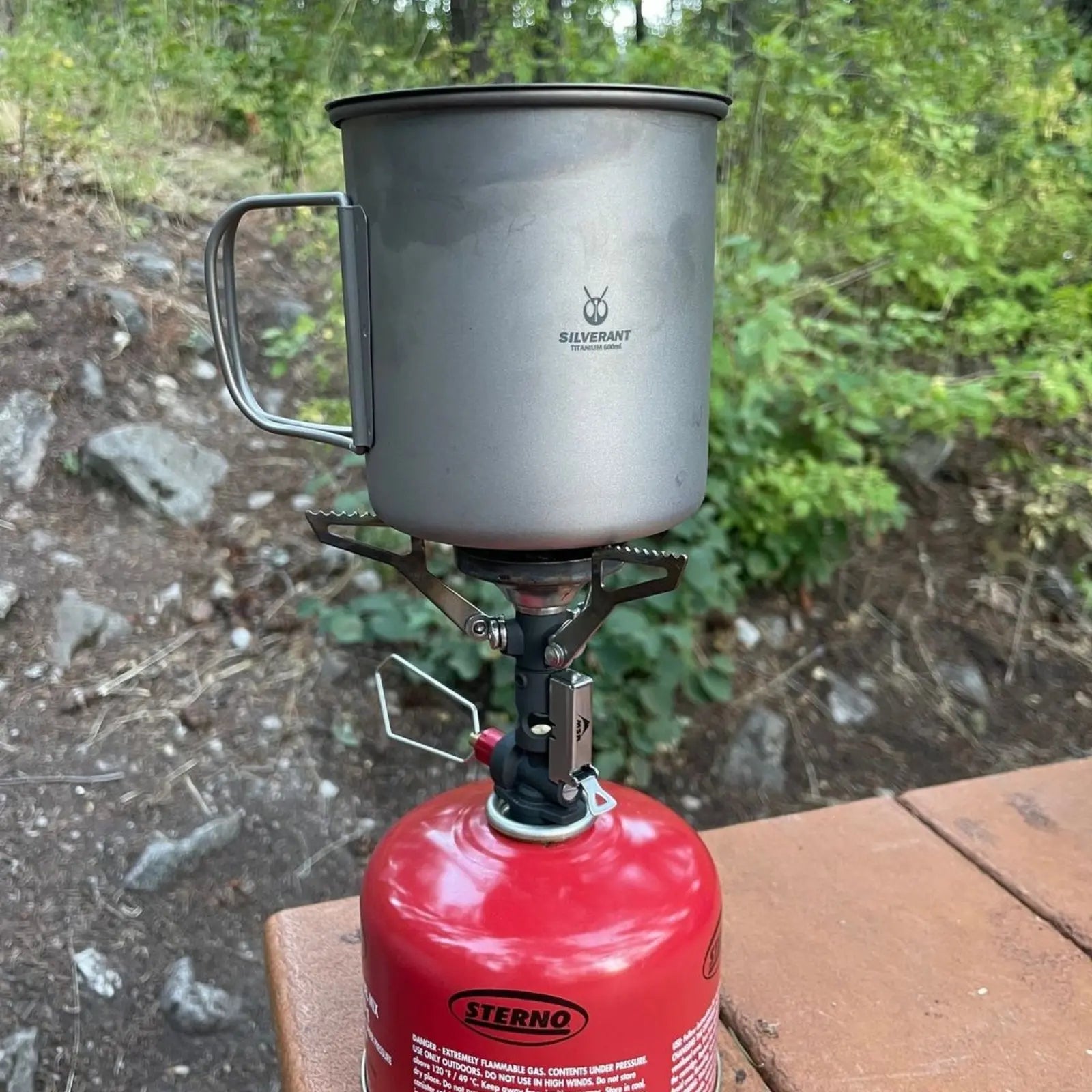 SilverAnt Ultralight Titanium Cup with Lid on a camping stove outdoors