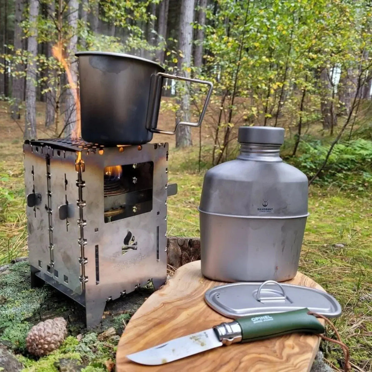 SilverAnt Titanium Canteen Military Mess Kit in an outdoor forest setting with camping gear.