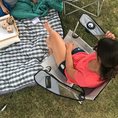 Relaxing outdoors with Core Equipment Tension Mesh Chair camping seat on a picnic day.