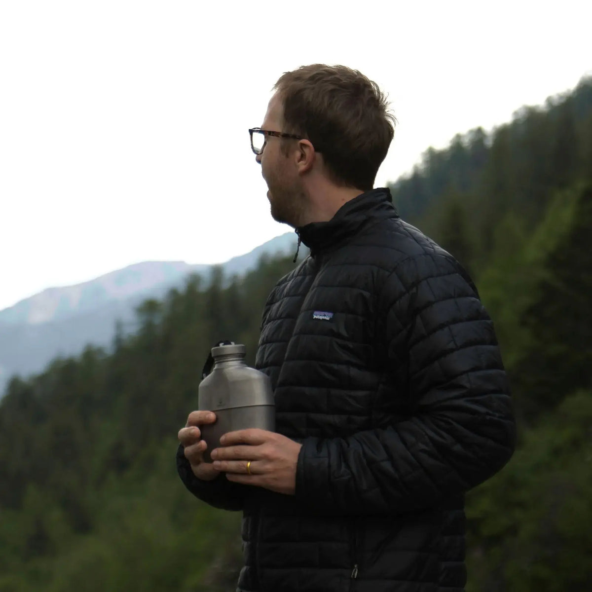 Man holding SilverAnt Titanium Canteen Military Mess Kit during a hike in the mountains