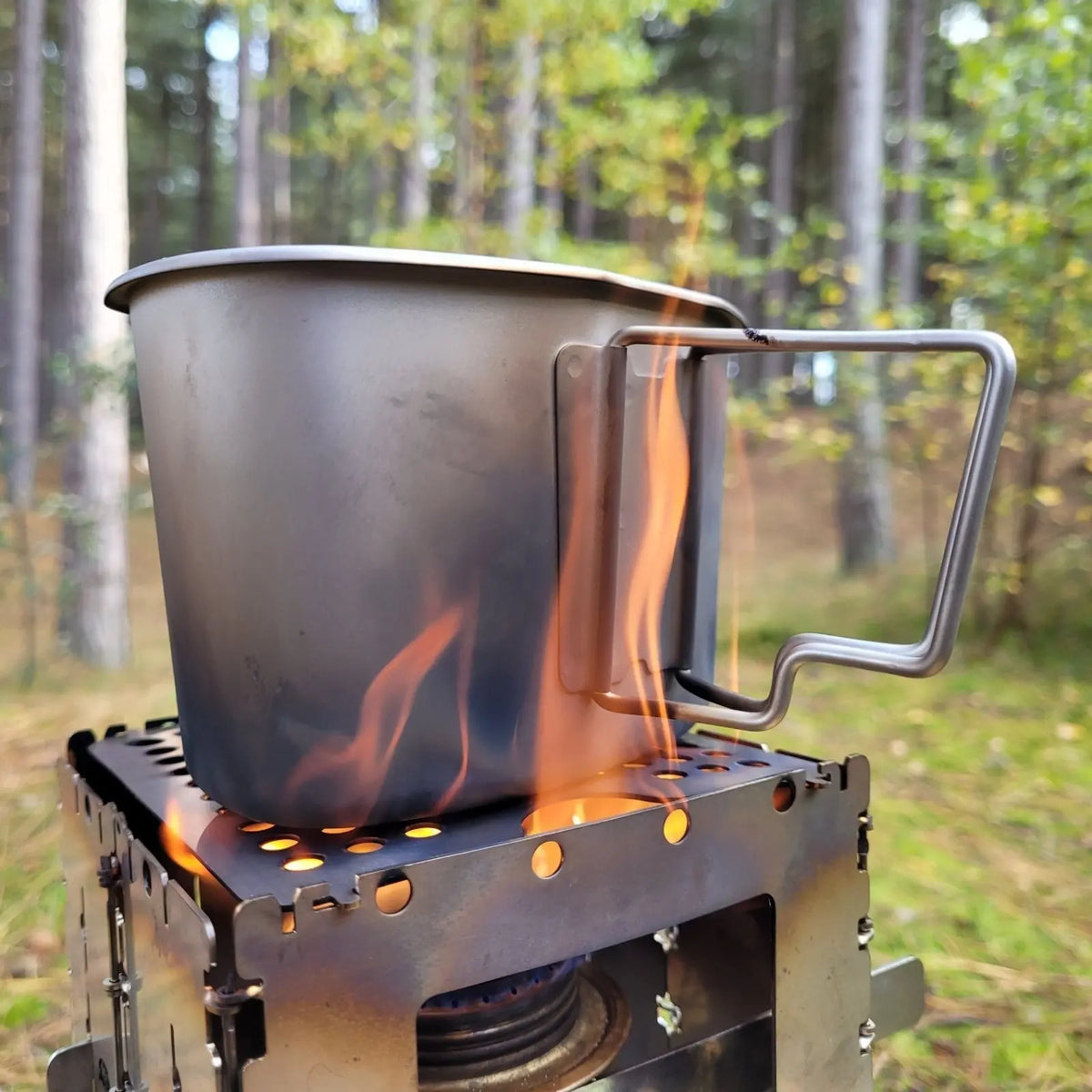 SilverAnt Titanium Canteen Military Mess Kit on outdoor stove in forest clearing.