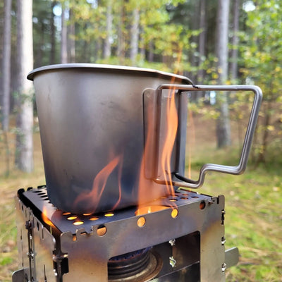 SilverAnt Titanium Canteen Military Mess Kit on outdoor stove in forest clearing.